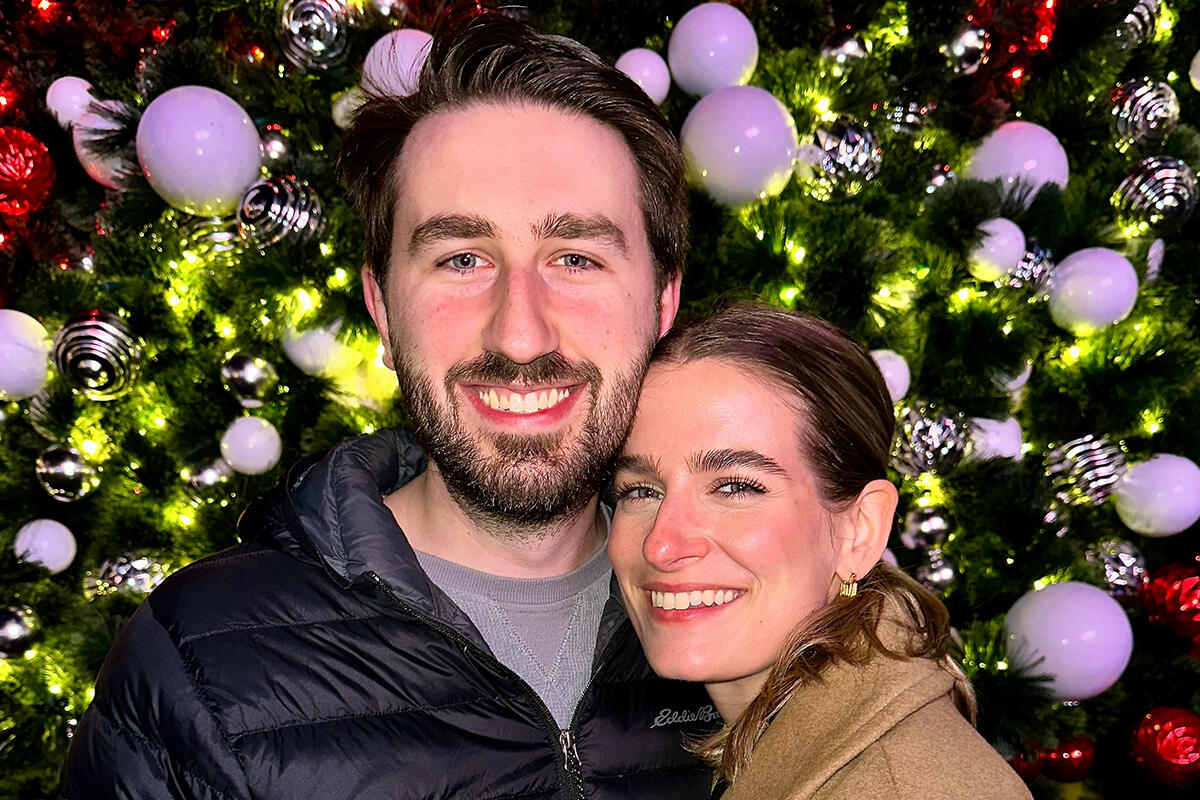 Rogers Christmas Rogers in front of tree.